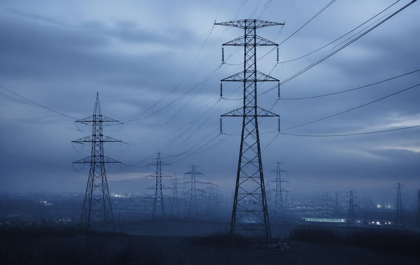 High-voltage transmission network at blue hour